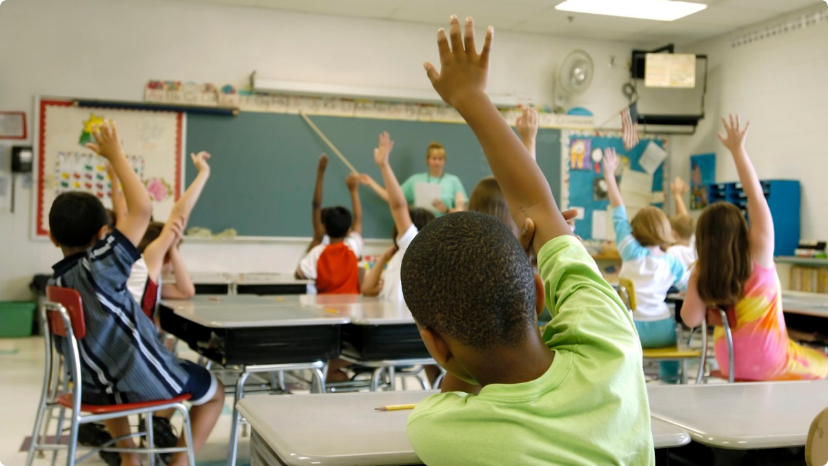 Kids Raising Hands in Classroom